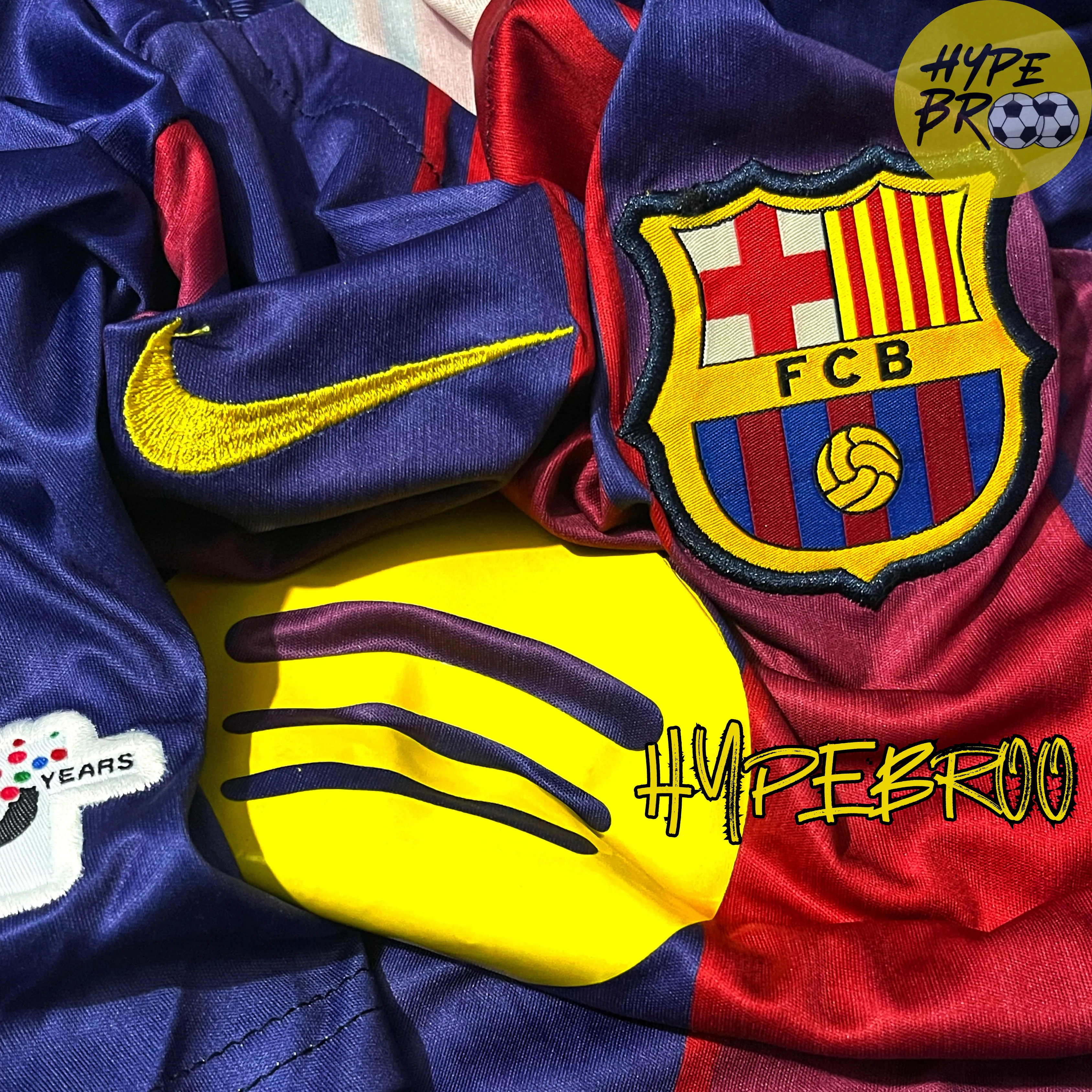 Close-up of Barcelona crest and Nike swoosh embroidery on 2025-26 home jersey