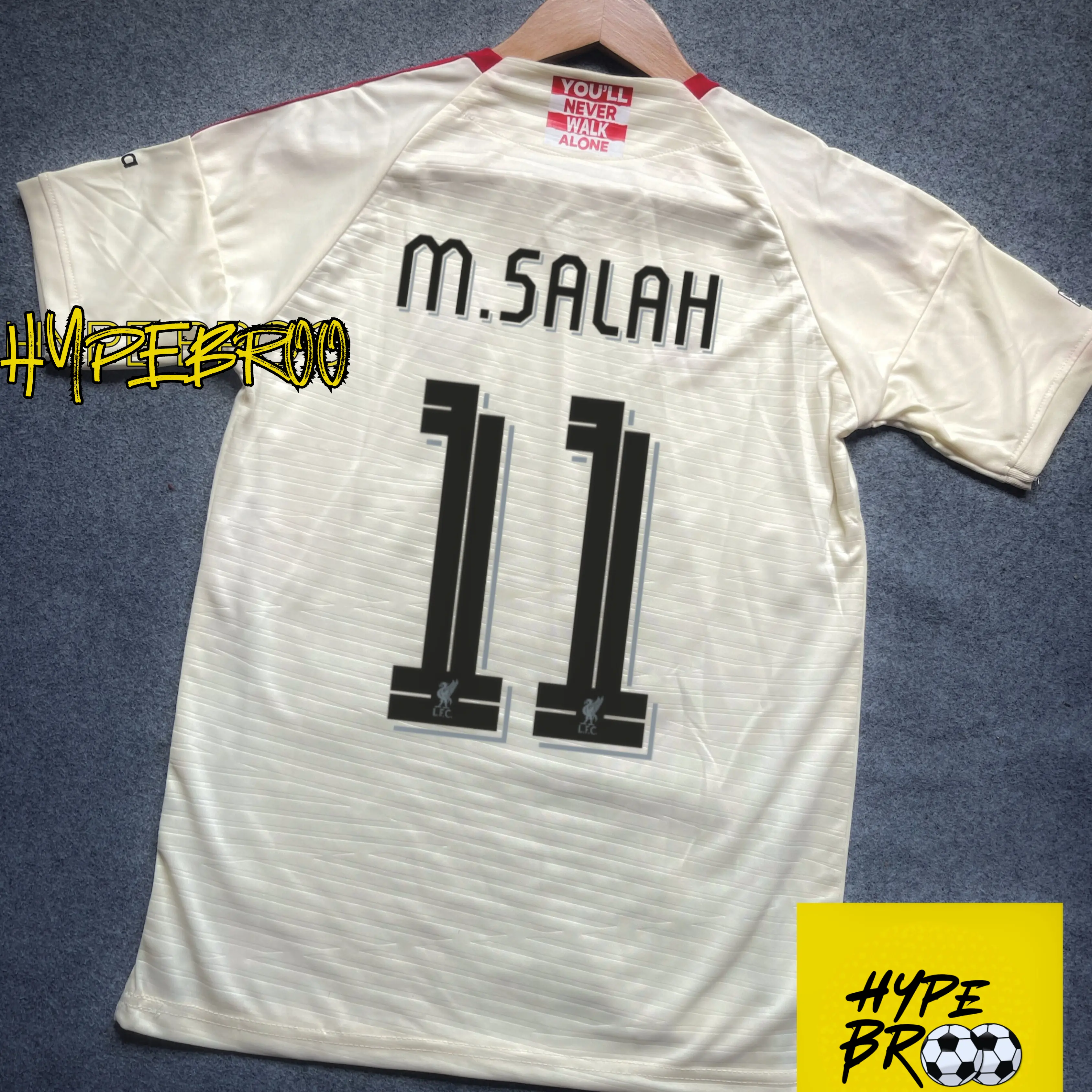 Liverpool 2025-26 away jersey back view laid on carpet with hanger