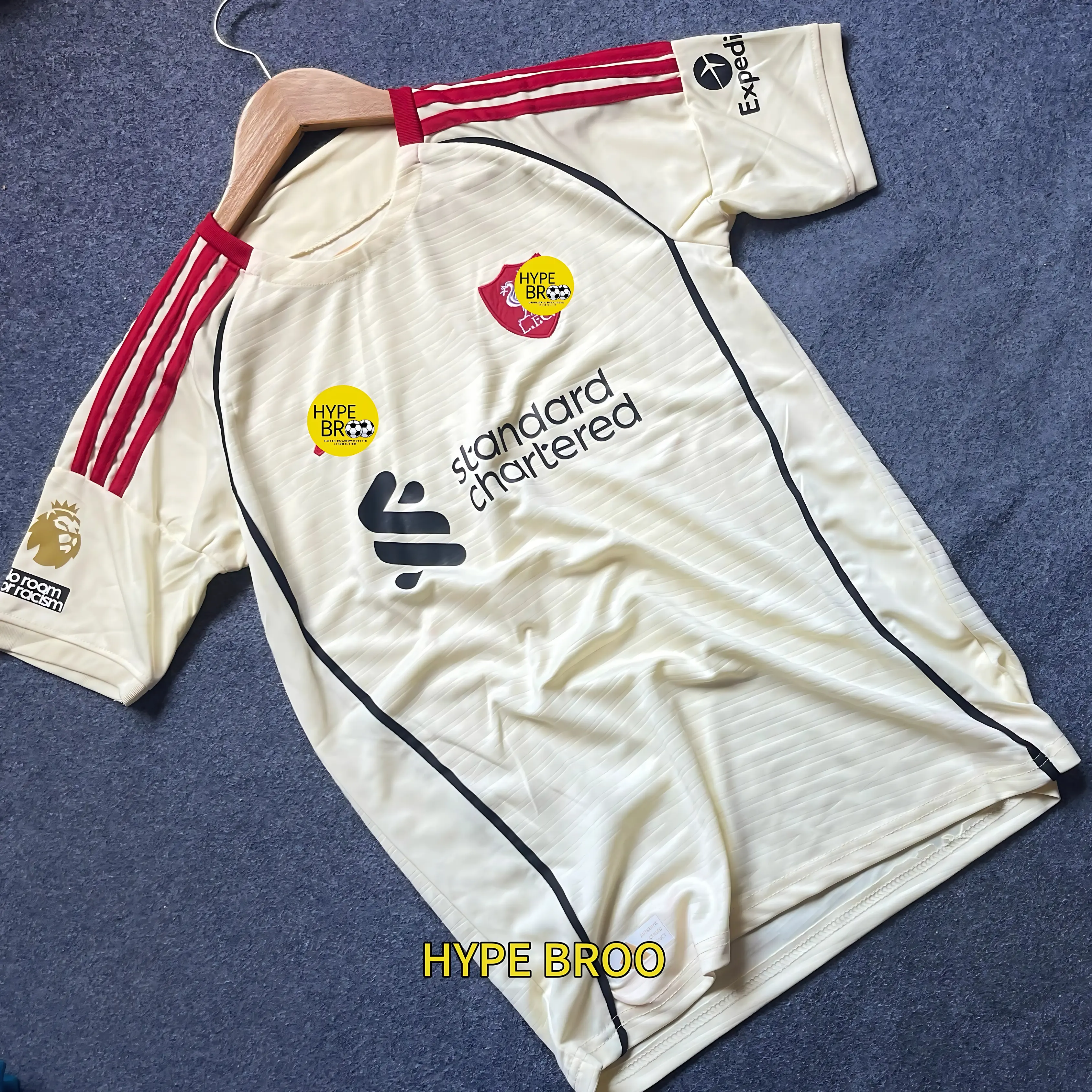 Liverpool 2025-26 away jersey front view laid on carpet with hanger