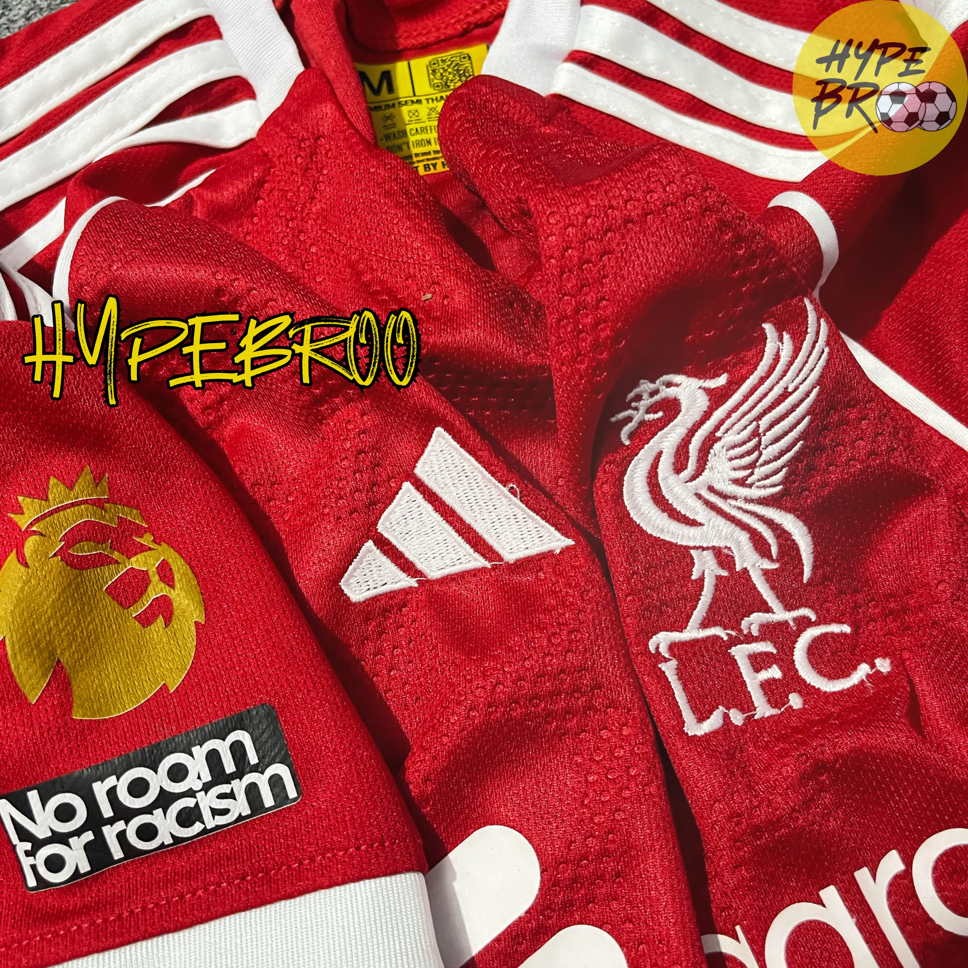 Close-up of Liverpool crest and Adidas logo on 2025-26 home jersey