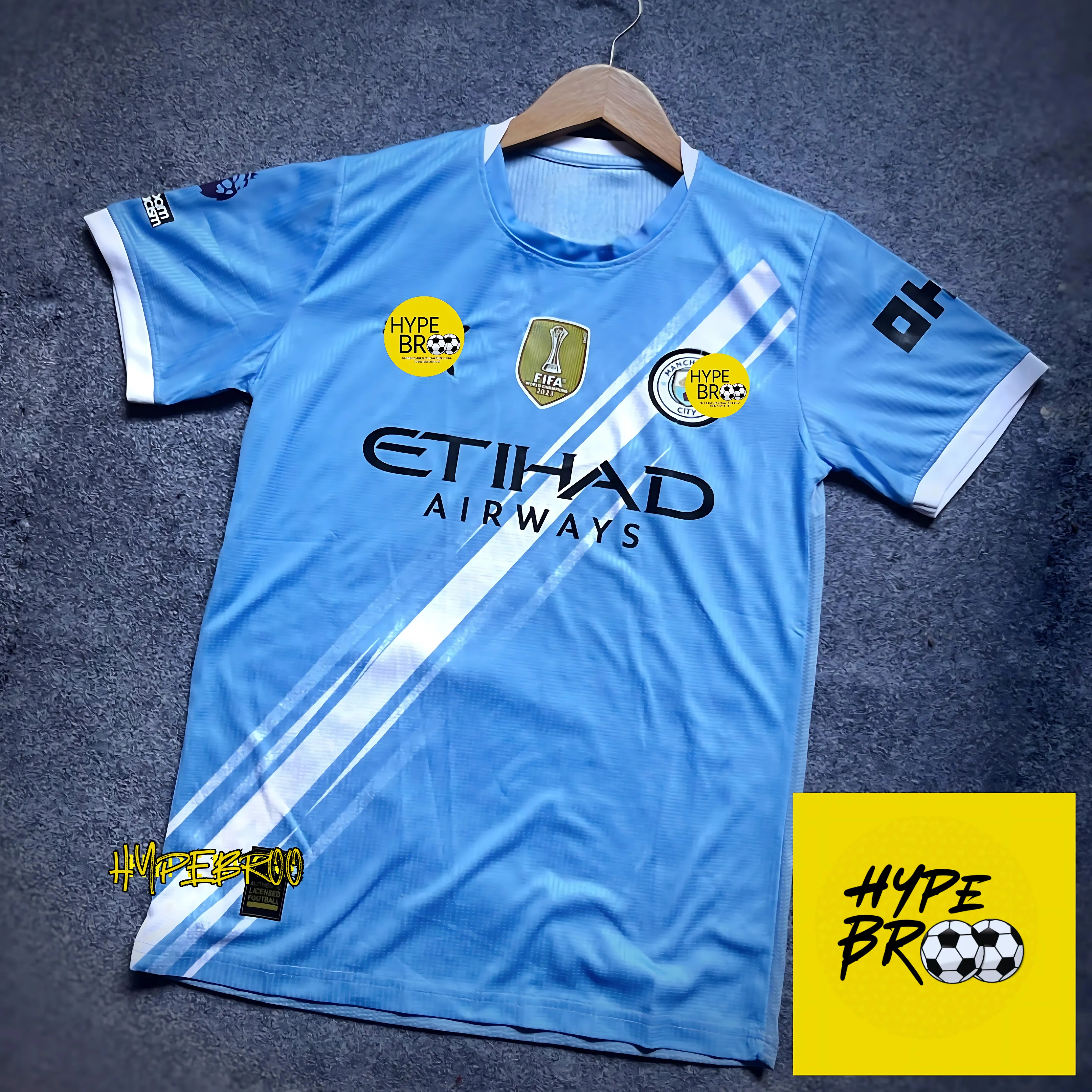 Manchester City 2025-26 home jersey front view laid on carpet with hanger